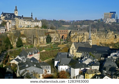 Luxembourg City view from Le Chemin de la Corniche or "Balcony of Europe". Alzette river, church of St Jean du Grund and Abbey de Neumunster