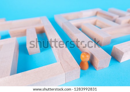 People in the maze, finding a way out. The man in the maze. The concept of a business strategy, analytics, search for solutions, the search output. Labyrinth of wooden blocks.