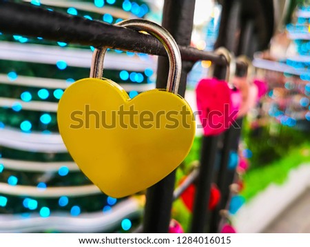 Couple red heart lock with key lean against vintage pole, vlentine love symbol.