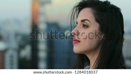 Ambitious latina hispanic girl overlooking at city view on top of rooftop