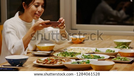Woman take photo on the dishes 