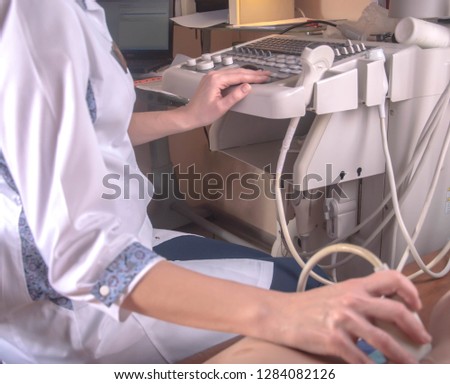 
the doctor conducts the patient ultrasound diagnosis