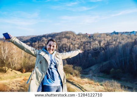 portrait of young pretty woman on the top of the hill