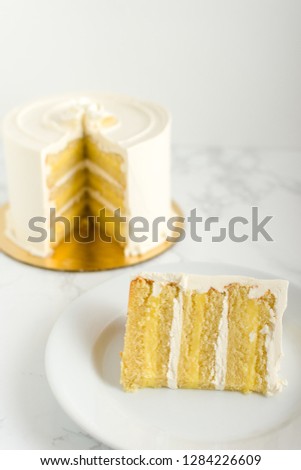 Slice of lemon cake on marble table.