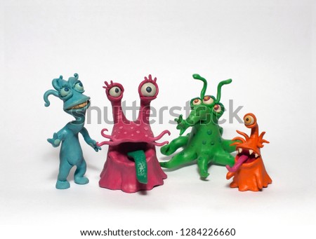 A group of four cartoon monsters bacteria. Plasticine characters on a white background.
 Royalty-Free Stock Photo #1284226660