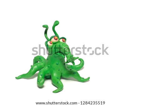 Green monster bacterium with tentacles and trunk. Plasticine character on a white background Royalty-Free Stock Photo #1284235519