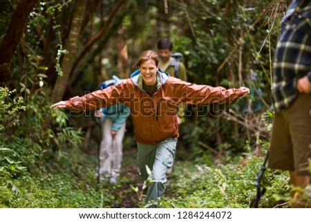 Middle aged woman laughing with arms outstretched