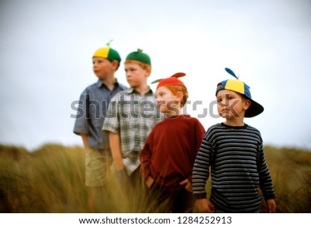 Boys wearing hats standing in line