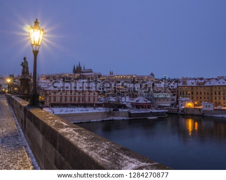 The night view of Prague Castle in winter captured from Charles bridge during the morning sunrise. Prague, Czech Republic.