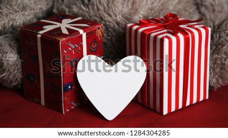 Happy Valentine's Day with dark background with gift box in white and red and heart and small dolls in love.