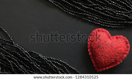 Happy Valentine's Day with dark black background and red heart and beads