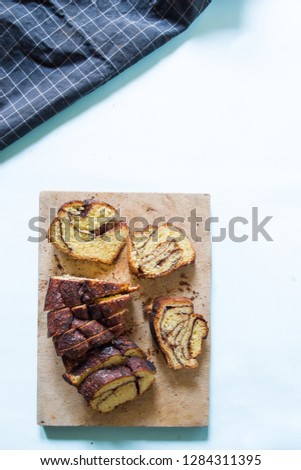 How to bake a babka jewish cake, series of images depictting how to make babka, based babka is ready to be eaten, over a blue background, easter concept.