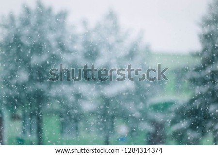 
Blurred background of snowstorm, falling snow in the village in winter