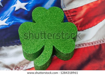 Lucky shamrock on USA wavy flag background with room for copy text