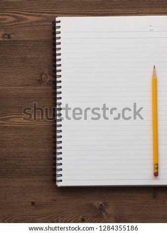 White notebook and pencil