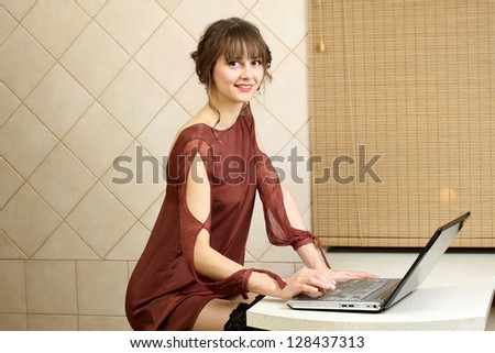 Ordinary girl working on a computer at home
