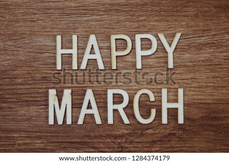 Happy March text message on wooden background