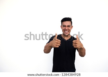 Handsome latin hispanic man showing cool gesture with thumb up isolated on white background. Place for text.