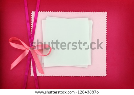 Empty card on pink fabric texture
