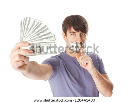 Young man holding a dollar bills  his mouth sealed by a hundred dollar bills isolated on white background