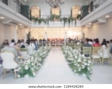 Blurred picture of wedding ceremony by there are a lot of guest that sitting and watching the ceremony. Wedding concept.