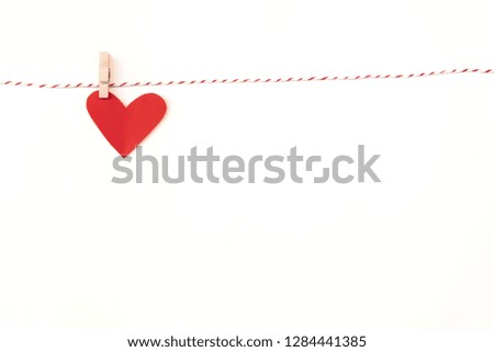 Paper hearts hanging on the clothesline.