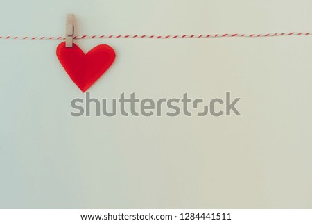 Paper hearts hanging on the clothesline.