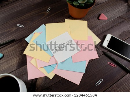 Flat lay, top view office table desk. Workspace with blank clip board, pencil, green leaf, and coffee cup on dark background. ?oncept for internet banners, marketing, promotion, business, startup