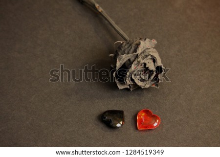 Black glass heart and black rose. Metal head, punk, emo lovers background. 