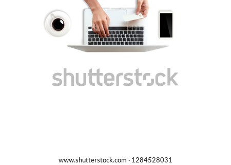 technology working table with woman hands on laptop computer, credit card, coffee cup and cell phone on white background (or shopping and payment online concept)
