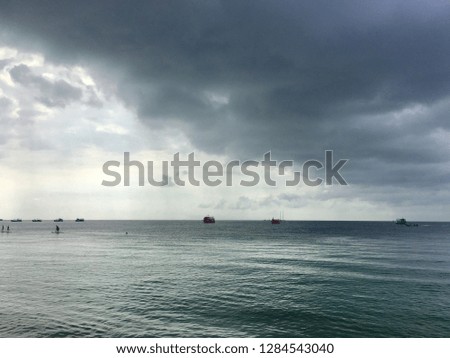 Dark ocean sky clouds boats panorama view