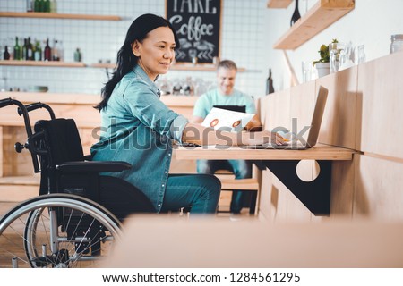 Financial report. Disabled qualified manager preparing a report