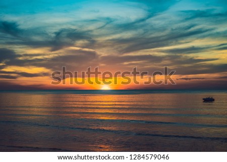 gold sunset over beach with wave splashes in summer of Thailand