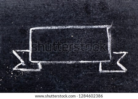 White chalk hand drawing in blank award ribbon or banner shape on black board background