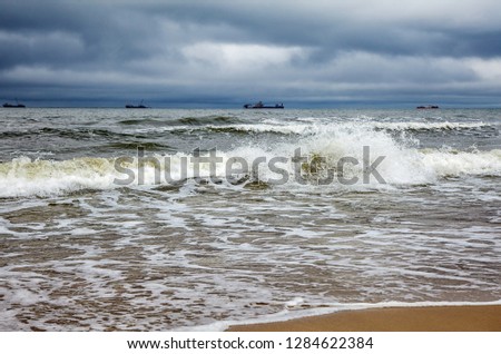 stormy baltic sea with ships on gloomy autumn day