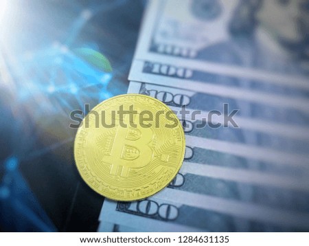 Bitcoin gold coins and one hundred dollar banknotes