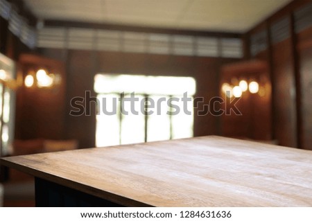 wooden table with blurred modern home background.