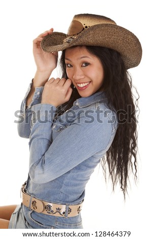 A woman in her cowgirl hat with a big smile on her face.
