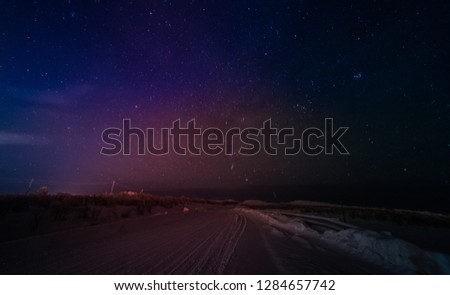 starry sky and winter landscape