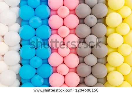 Abstract background from pattern of mixed colorful balloons decorated on wall. Party and celebration backdrop.