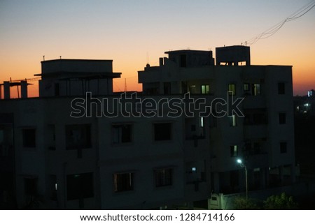 Sunset over the buildings cityscape and the silhouette buildings.India