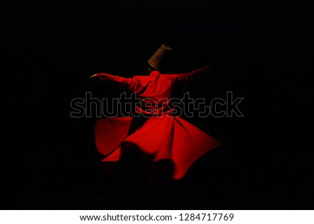 Whirling Dervish with red costume on black background Royalty-Free Stock Photo #1284717769