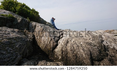 Photographer taking photo of the Atlantic