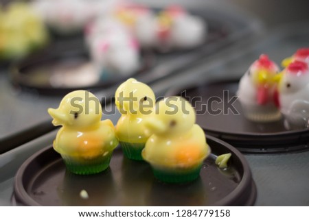 Delicious sweet duck shaped jelly pudding or agar with plastic container for dairy foods with space. Dessert concept background. Selective focus.