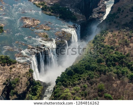 Awesome aerial view of Victorian waterfalls. View from helicopter. Victoria falls is a waterfall in southern Africa on the Zambezi River at the border of Zambia and Zimbabwe.