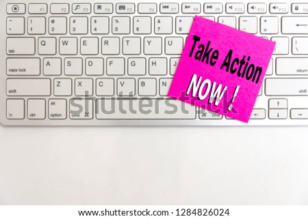 Take action now writing text post it in office on notebook computer keyboard. Time For Action word note pad paper on laptop for copy space. top view. 