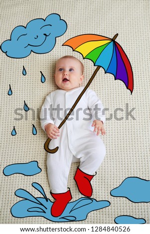Baby with umbrella and rainfall concept
