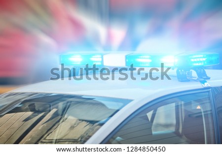 Police car with blue lights on the crime scene in traffic / urban environment. Royalty-Free Stock Photo #1284850450