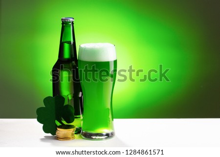 Buttle and glass of fresh green cold beer. Concept for St. Patrick's day.