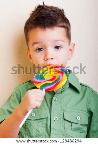 Cute boy with large lollipop in his lips